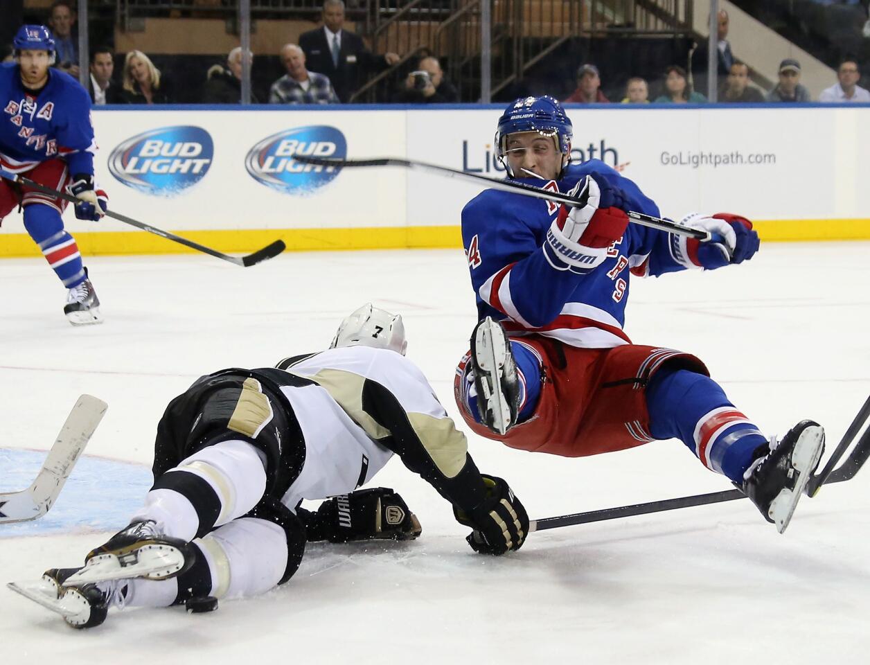 Paul Martin of the Pittsburgh Penguins trips up Ryan Callahan of the New York Rangers during the second period at Madison Square Garden on Nov. 6 in New York.