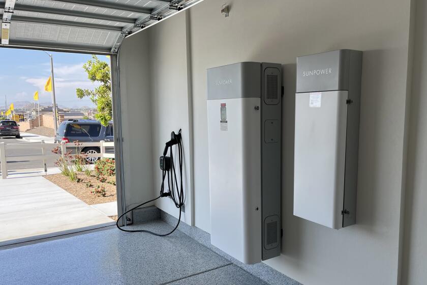 The garage of an all-electric, solar powered home in a new KB Home subdivision in Menifee includes a battery storage system that can power the home during an outage and in the evenings when the cost of electricity from the grid is higher. (Tony Barboza/Los Angeles Times)