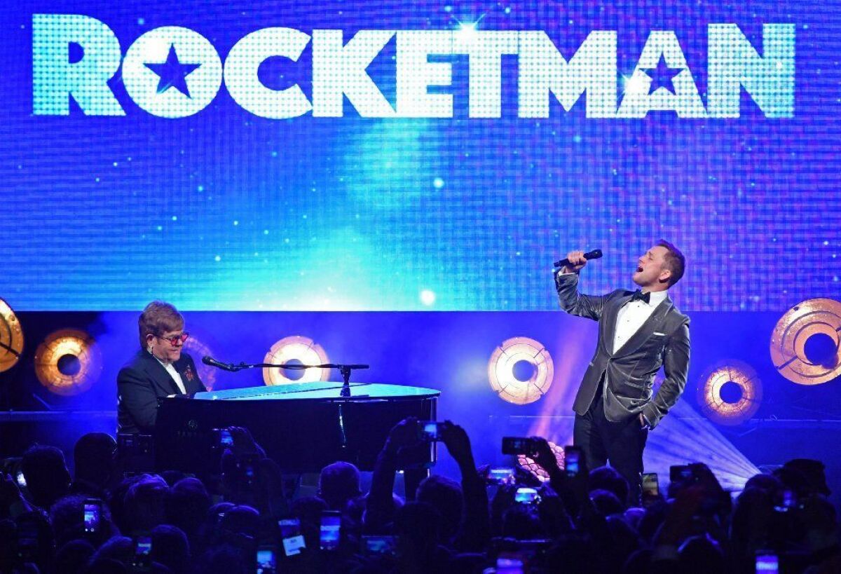 Elton John performs with Taron Egerton, who plays him in "Rocketman," at the gala party after the film's Cannes Film Festival world premiere.