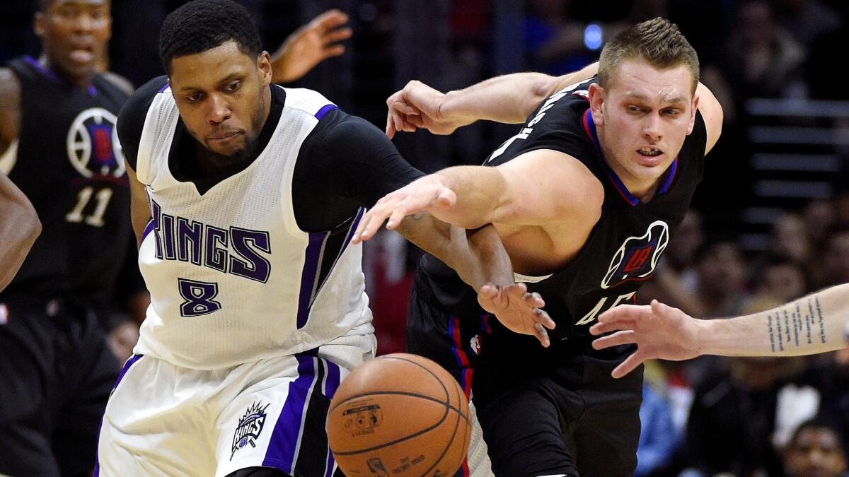 Clippers center Cole Aldrich and Kings forward Rudy Gay (8) try to track down a loose ball during their game Saturday night.