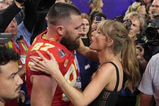 Kansas City Chiefs tight end Travis Kelce (87) speaks to Taylor Swift after the NFL Super Bowl 58 football game against the San Francisco 49ers, Sunday, Feb. 11, 2024, in Las Vegas. The Chiefs won 25-22. (AP Photo/John Locher)
