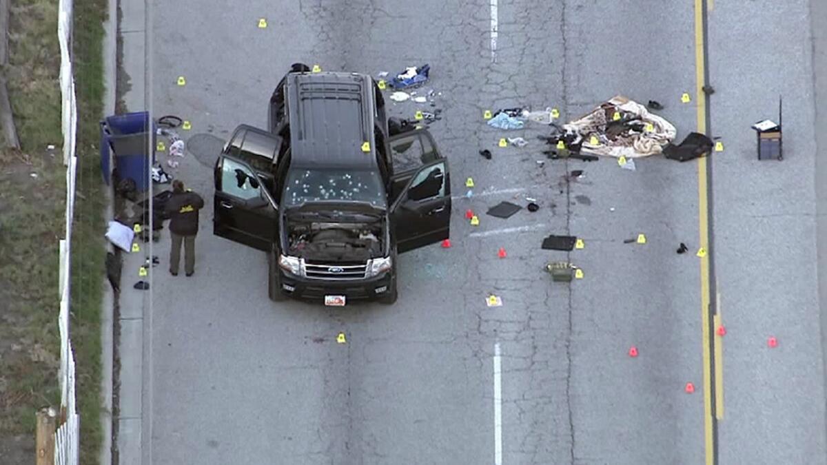 Investigators search the suspected assailants' SUV in San Bernardino on Thursday morning.