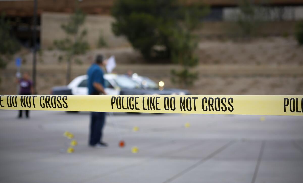 A member of the San Diego Police Department investigates the scene where an officer shot and killed a 15-year-old boy.
