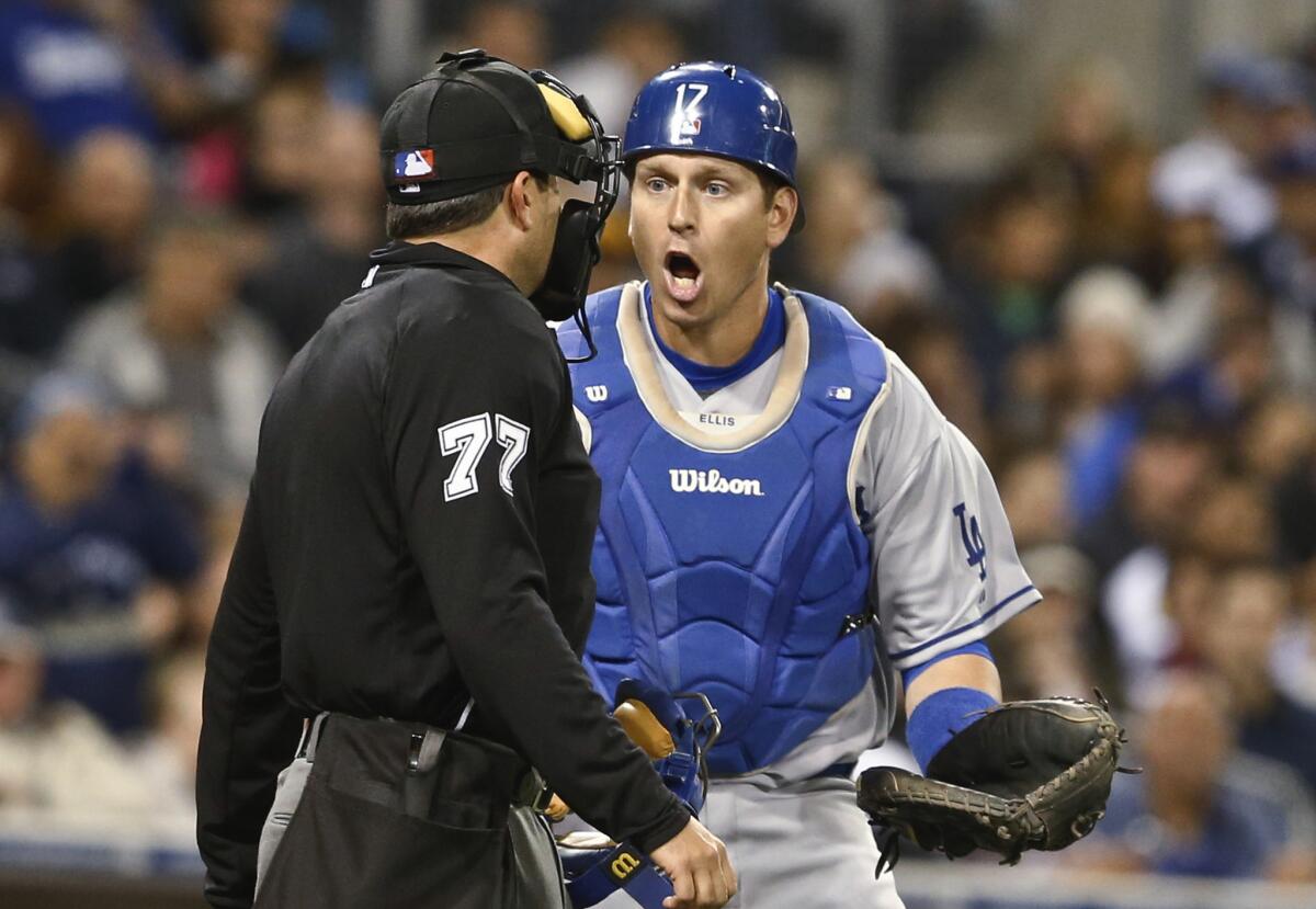 Dodgers catcher A.J. Ellis questions an interference call by umpire Jim Reynolds during the fourth inning of a game against the San Diego Padres on April 2, 2014.