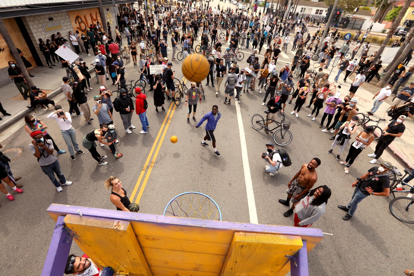 Protesters shoot hoops while taking a break from marching
