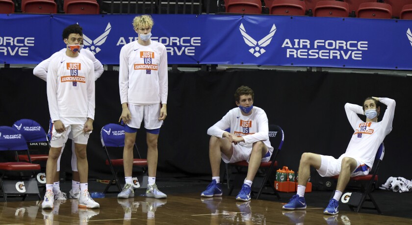 Players on the Boise State bench watch during the final minutes of the team's NCAA college basketball game against Nevada in the quarterfinals of the Mountain West Conference men's tournament Thursday, March 11, 2021, in Las Vegas. (AP Photo/Isaac Brekken)