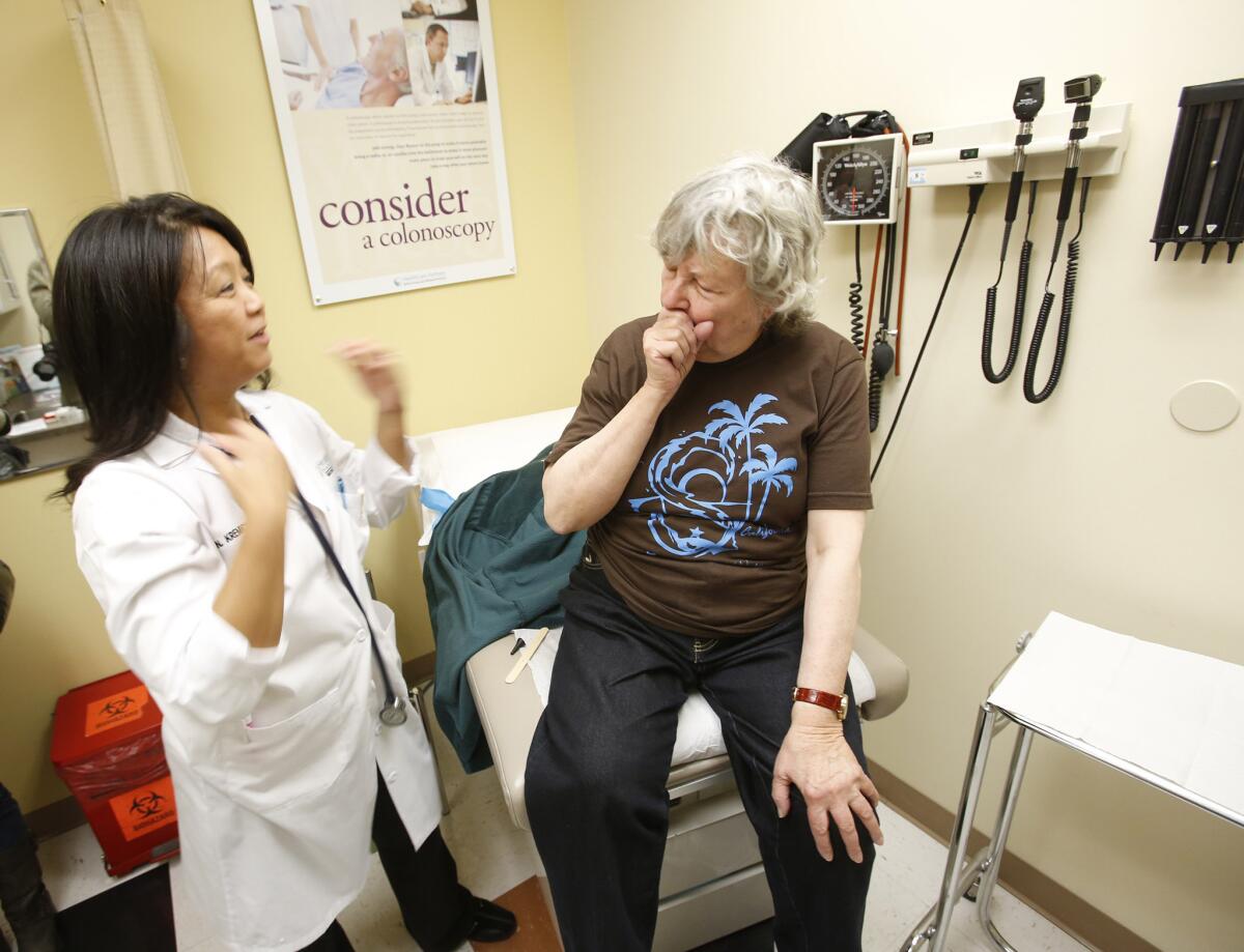 Marilyn Ducote, 81, right, is examined by Norinda Kremicki, a nurse practitioner at the Healthcare Partners West Hills Clinic, after Ducote came in with a bad cough.