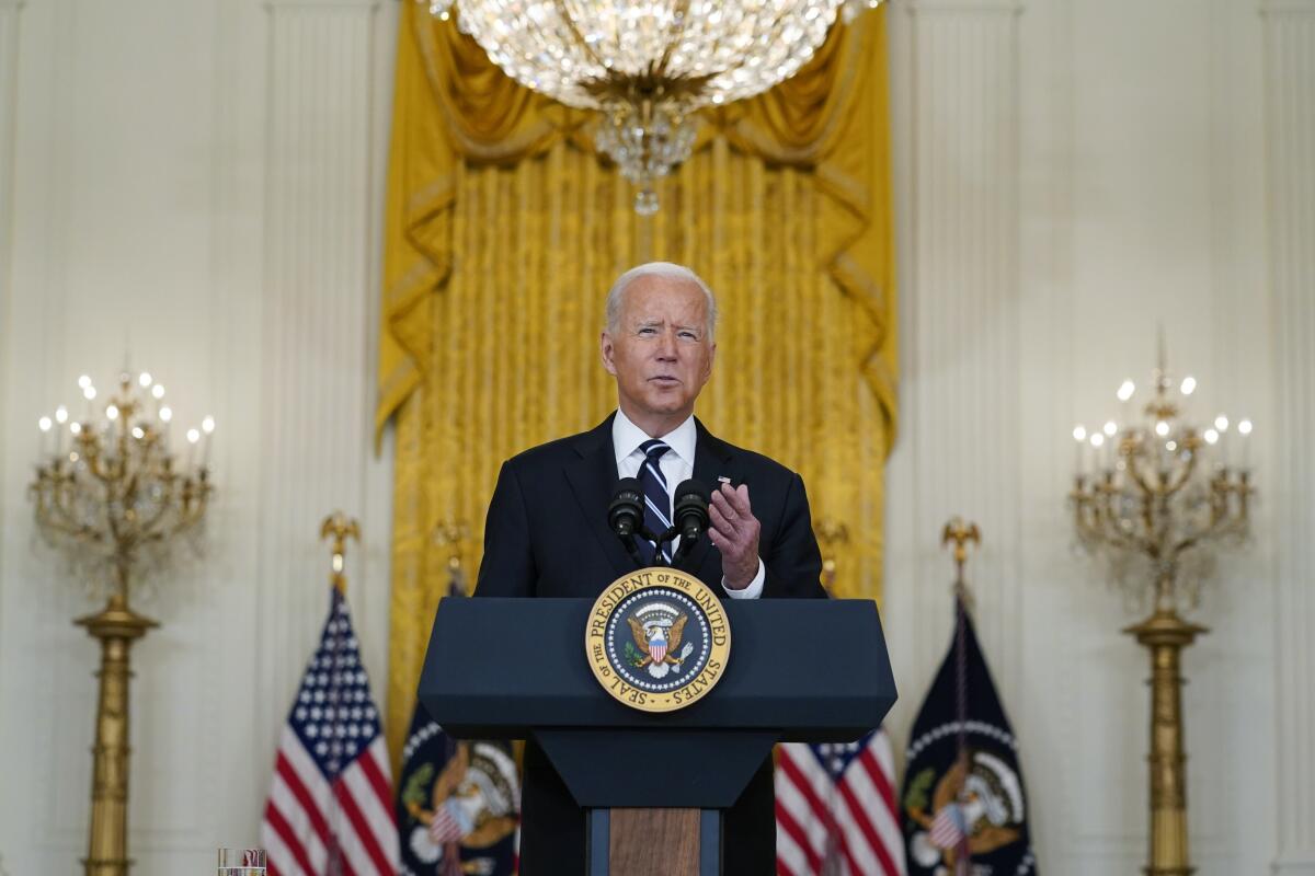 President Biden speaks from behind the presidential lectern at the White House