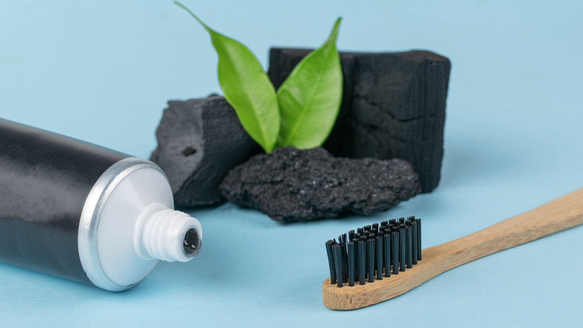 Eco-Friendly Bamboo Toothbrush and Activated Charcoal Toothpaste for Natural Oral Care.
