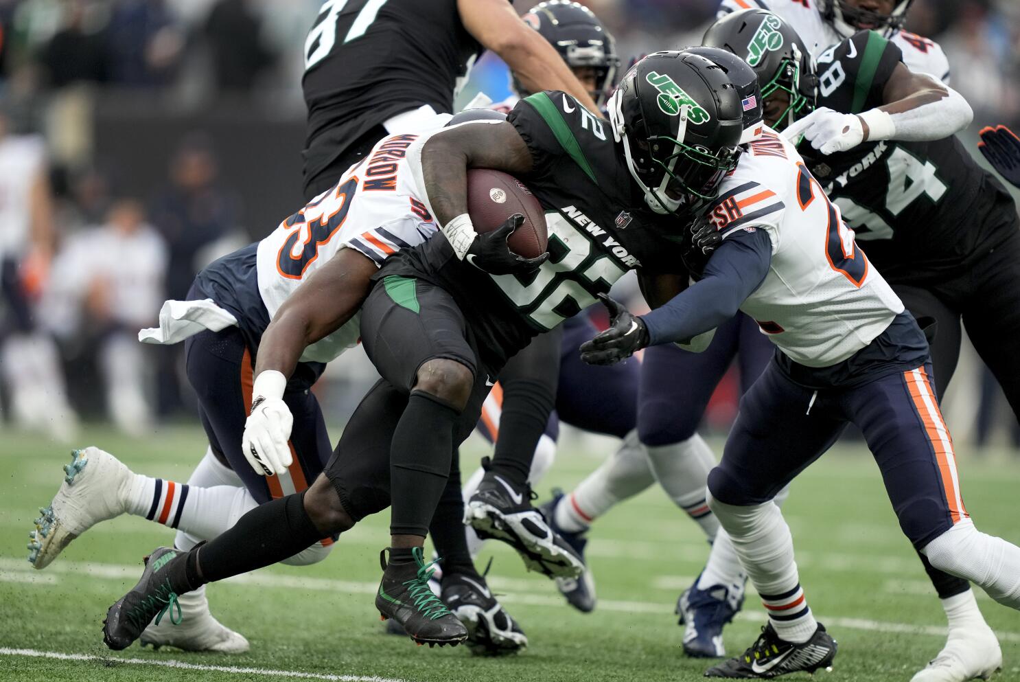 New York Jets' Michael Carter , right, runs the ball into the end