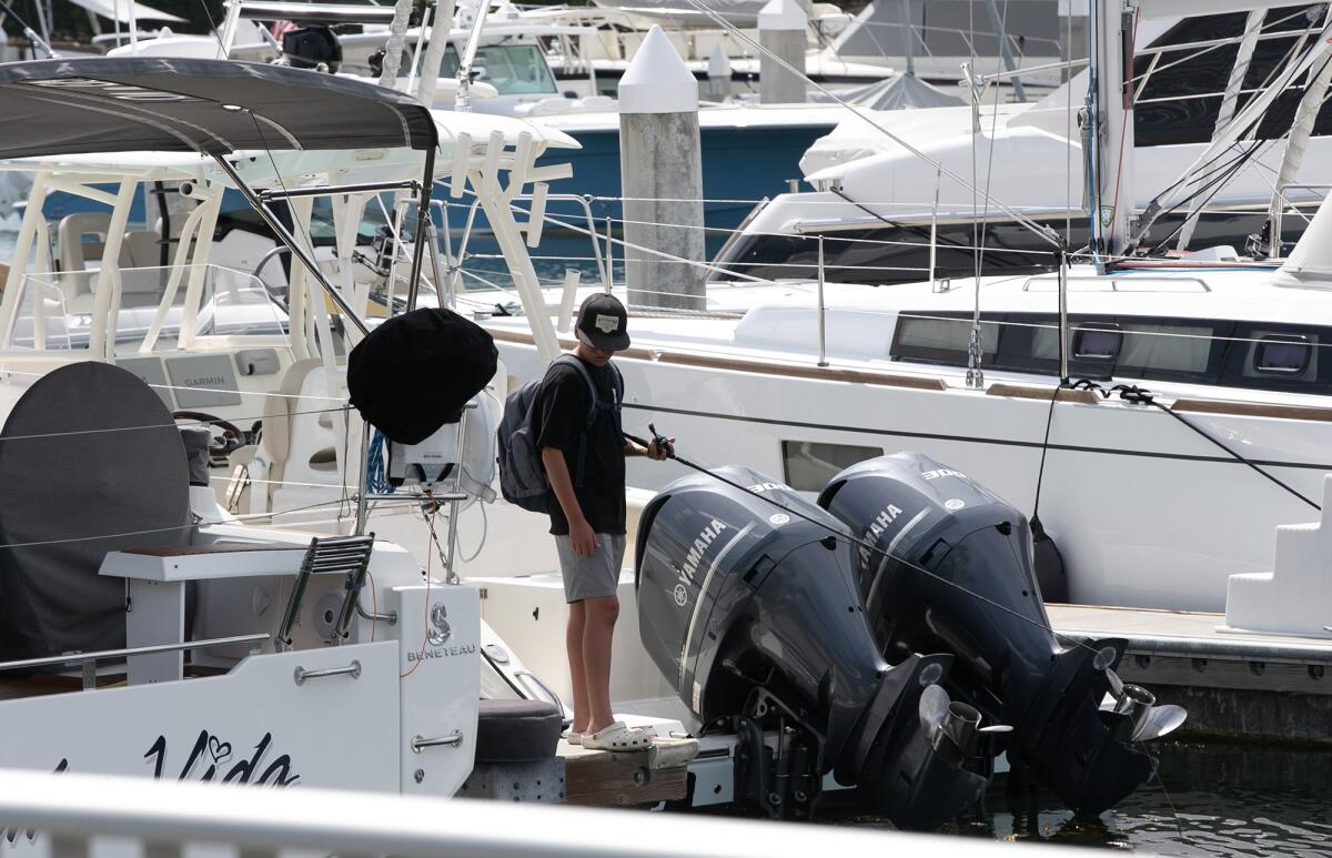 A boy fishes in Newport Beach on Monday, the day after a nearby sewage spill was reported.