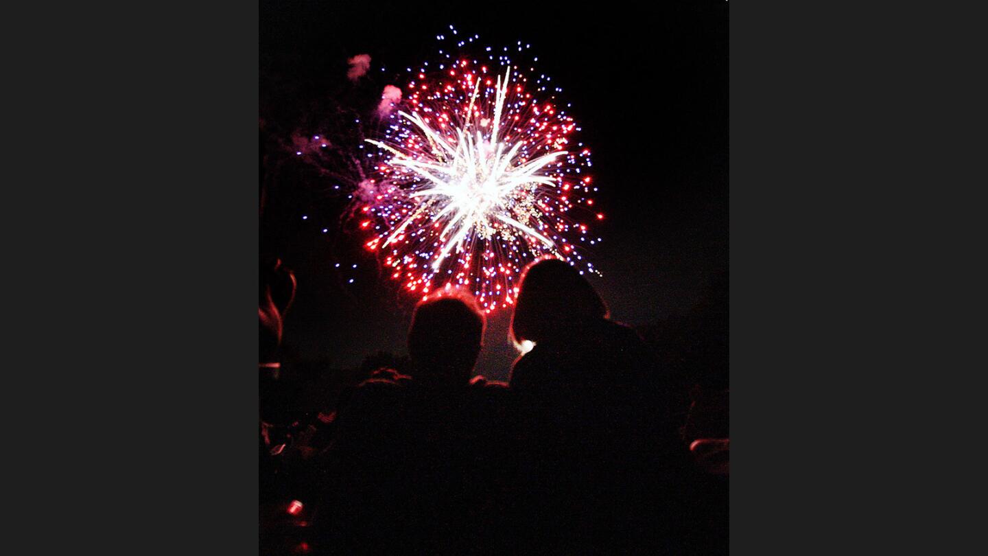 A couple enjoy the fireworks at the Starlight Bowl fireworks show in Burbank on Tuesday, July 4, 2017.