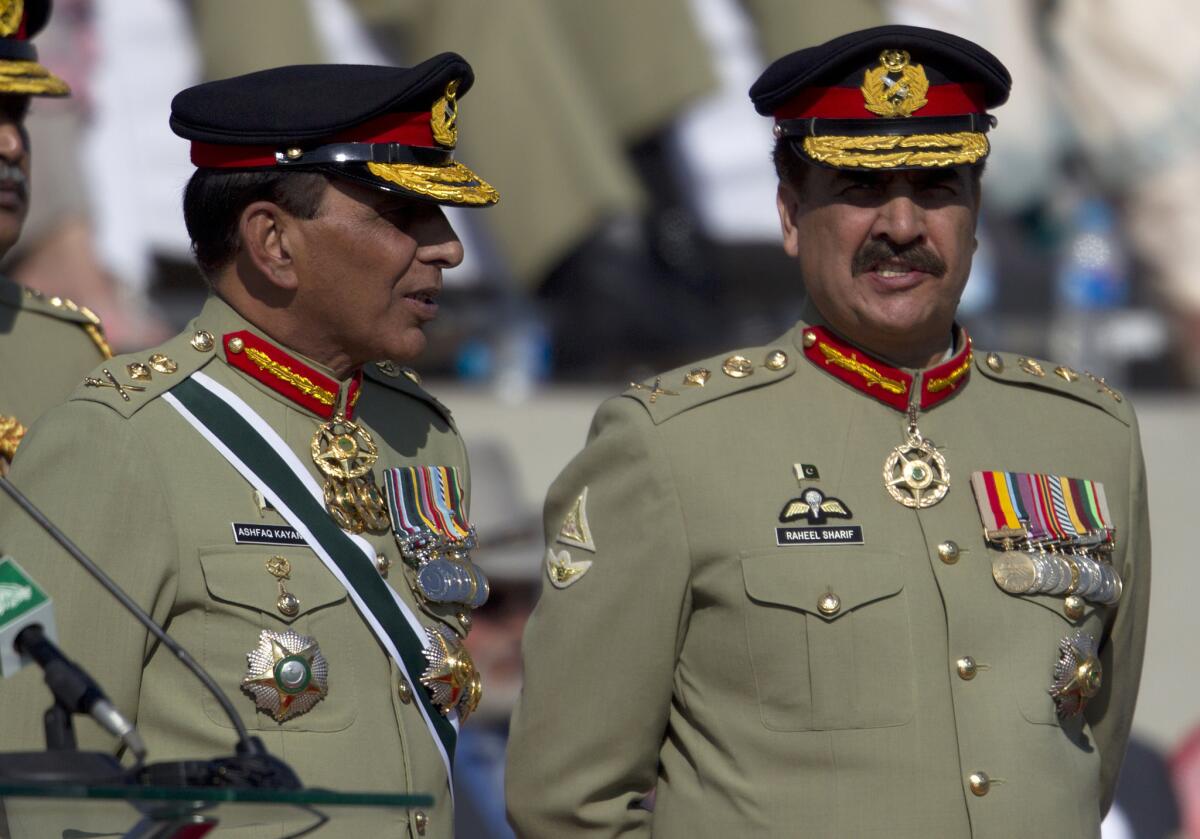 Pakistan's outgoing army chief Gen. Ashfaq Kayani, left, talks with his successor Gen. Raheel Sharif at a command changing ceremony in Rawalpindi, Pakistan.