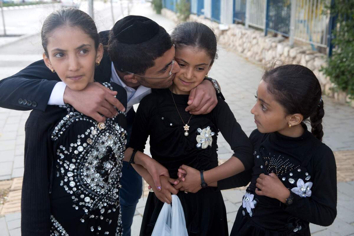 Zion Dahari hugs his sisters Malka, right, Hodaya, center, and Ester, left, after the girls arrived at an immigration centre in the Israeli city of Beersheba on March 21 following a secret rescue operation in Yemen.