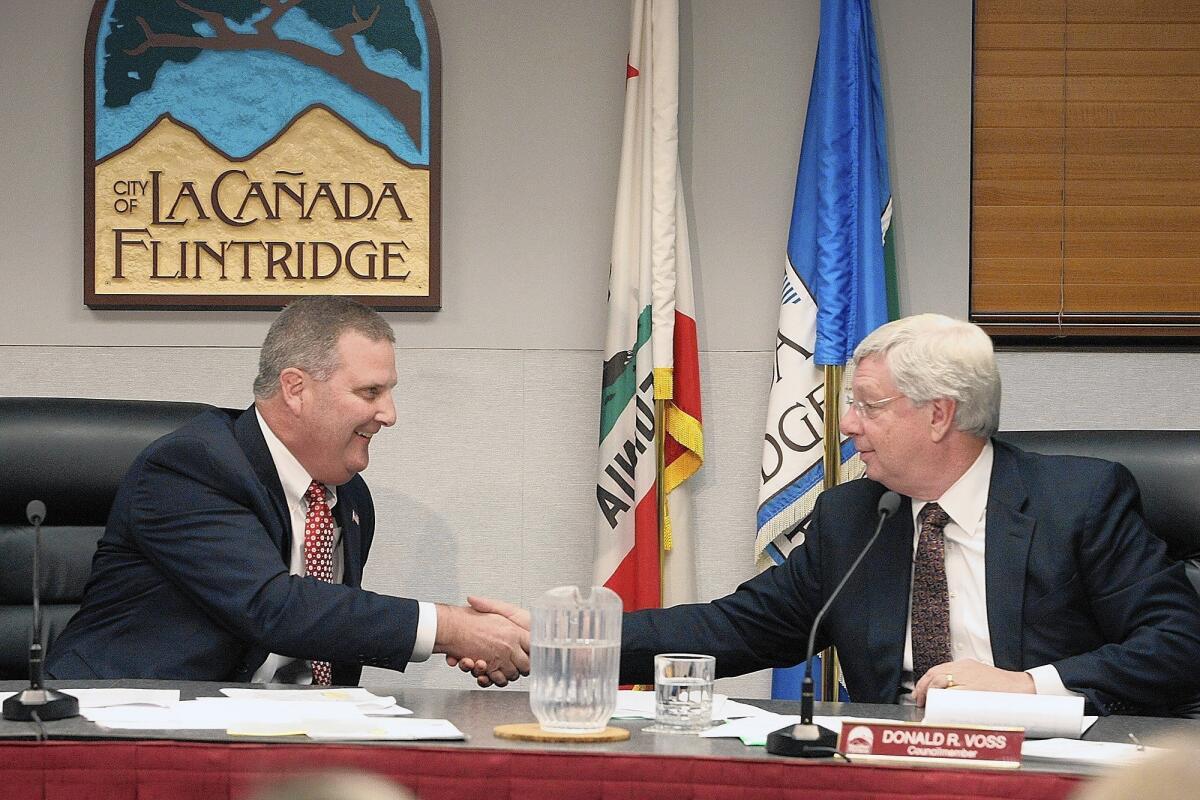 New La Cañada mayor Michael Davitt shakes hands with new mayor pro tem Donald Voss on Monday, April 7, 2014.