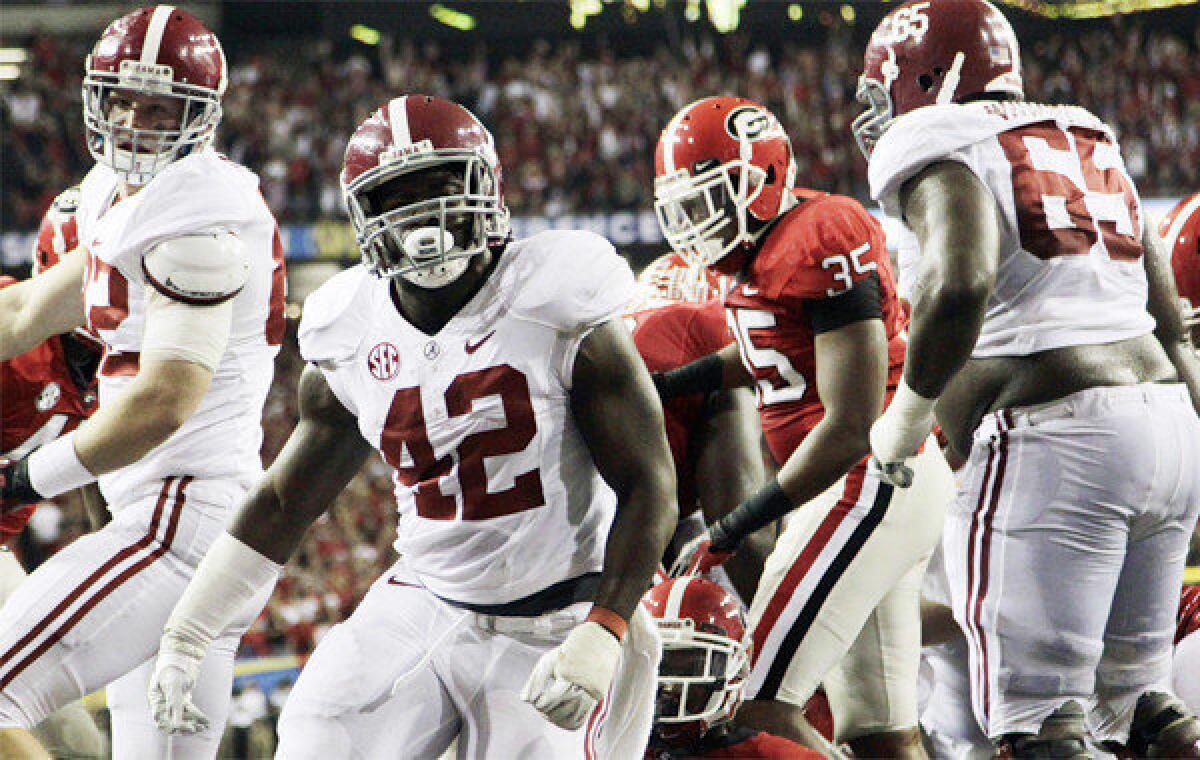 Alabama running back Eddie Lacy (42) reacts after scoring one of his two touchdowns in the Crimson Tide's 32-28 victory over Georgia in the SEC championship game.