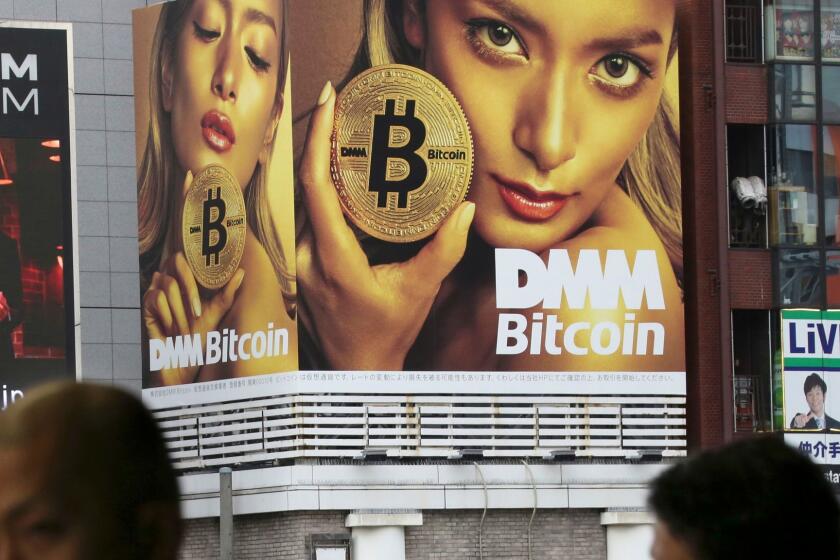 A huge advertisement of Bitcon is displayed near a train station in Tokyo Monday, Jan. 29, 2018. Blockchain is a decentralized technology that can make transactions safe and secure, but crypto-currency exchanges that trade bitcoins and other virtual currencies that are based on this technology have been hacked because they are not working on secure networks. (AP Photo/Koji Sasahara)