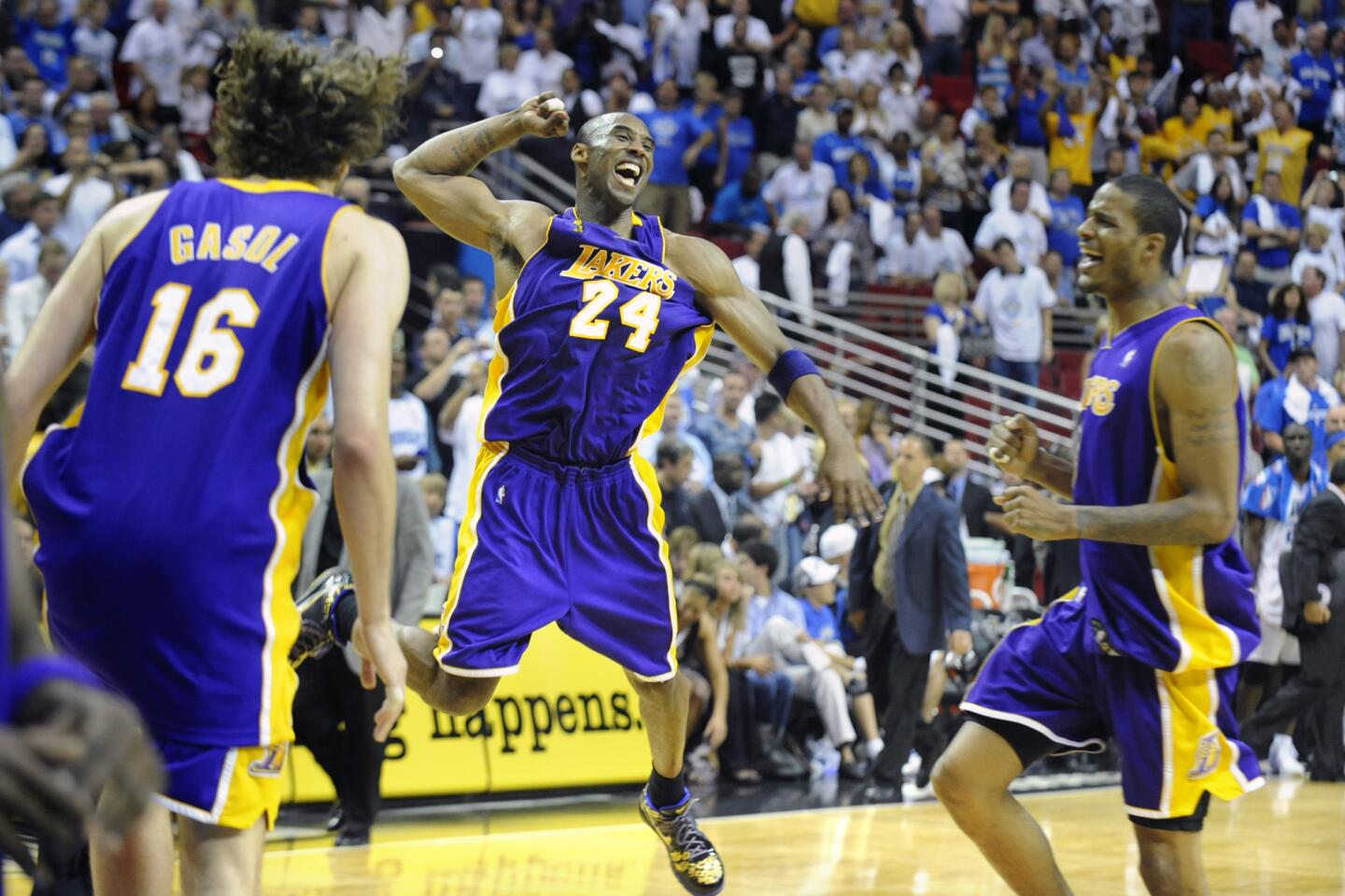 Kobe Bryant jumps for joy as Pau Gasol, left, and Trevor Ariza approach after the Lakers won the 2009 title.