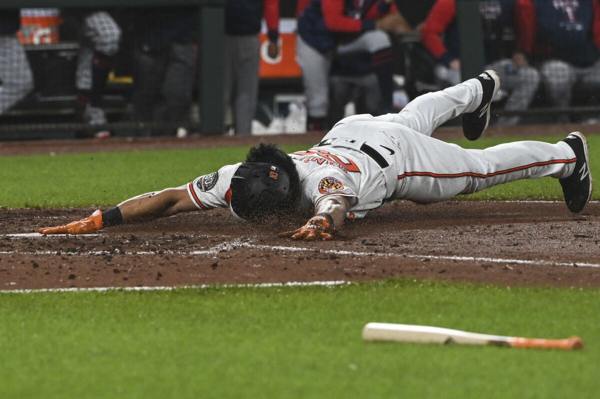 Baltimore Orioles' Anthony Santander scores on a Rougned Odor single during the fourth inning of the team's baseball game against the Minnesota Twins, Wednesday, May 4, 2022, in Baltimore. (AP Photo/Tommy Gilligan)