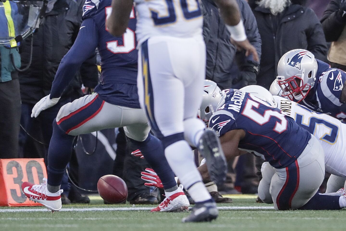 New England Patriots linebacker Albert McClellan dives on a ball fumbled by Chargers punt returner Desmond King Jr. during second quarter action in the NFL AFC Divisional Playoff at Gillette Stadium.