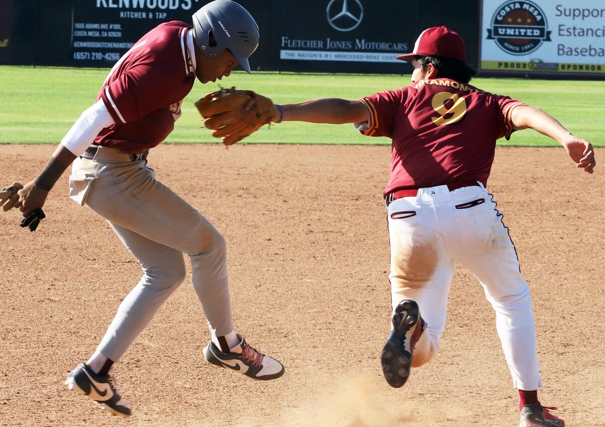 Estancia's Nico Viramontes (9) tags out Rancho Mirage's Kobee Finnikin (4) during Tuesday's game.