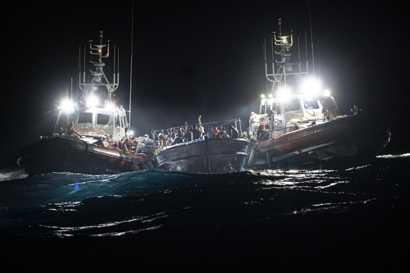 Migrants are rescued off the coast of Lampedusa on Tuesday Jan. 25, 2022. Seven migrants have died and some 280 have been rescued by the Italian Coast Guard after they were discovered in a packed wooden boat off the coast of the Italian island of Lampedusa. (AP Photo/Pau de la Calle)