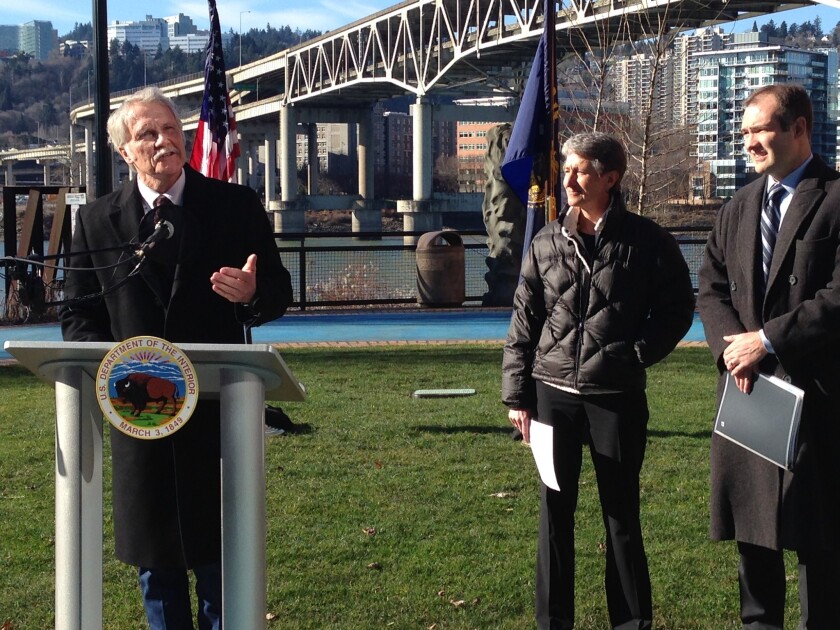 Oregon Gov. John Kitzhaber, left, with Interior Secretary Sally Jewell, announces plans to develop the West Coast's first offshore wind energy farm. Bureau of Ocean Energy Management Director Tommy Beaudreau is at right.