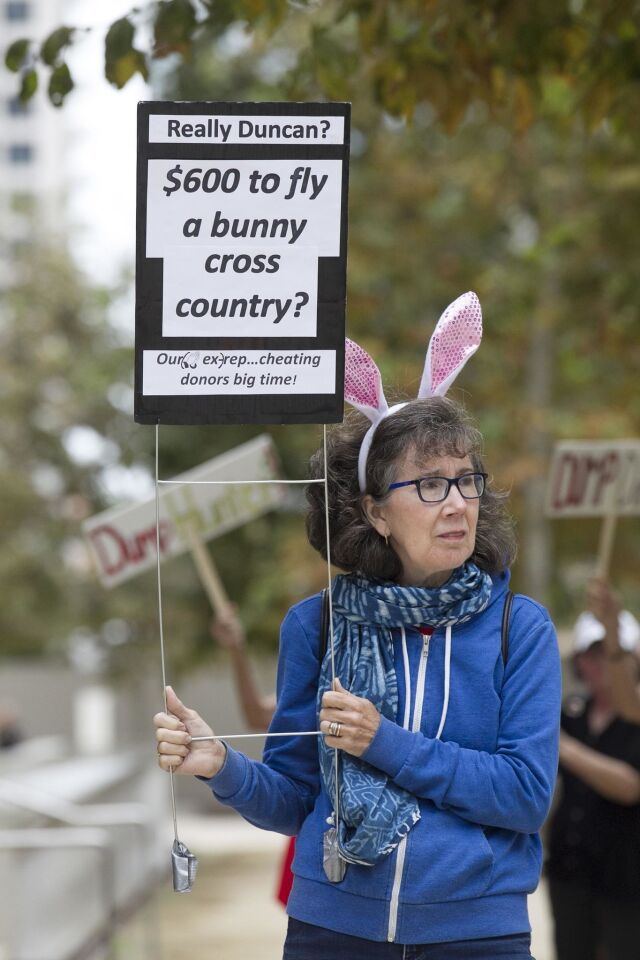Protester Judy Harrington made reference to one of the more controversial expenses Hunter allegedly paid for with campaign funds.