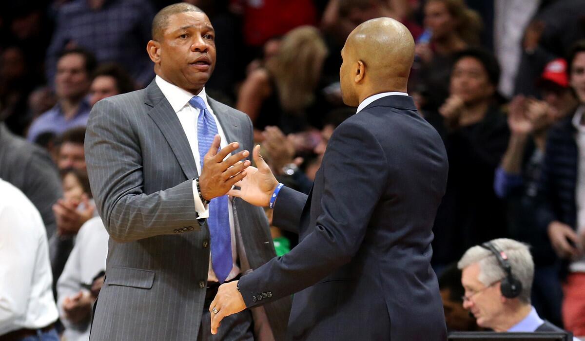 Clippers Coach Doc Rivers greets Knicks Coach Derek Fisher before their game Wednesday night at Staples Center.