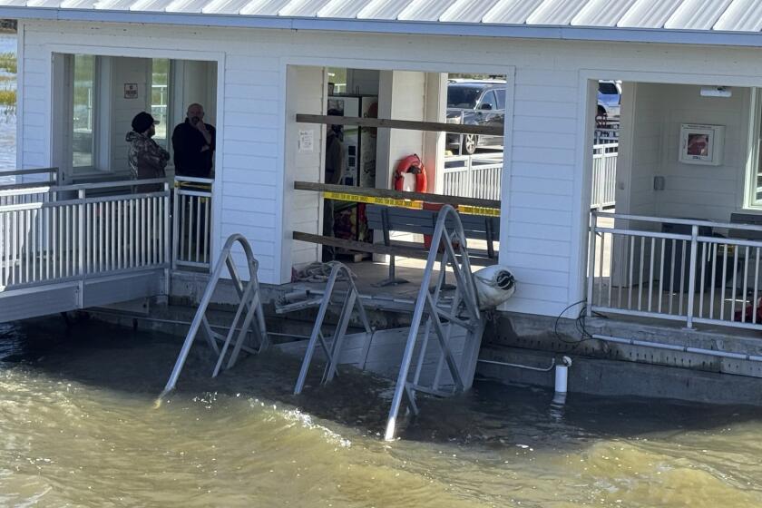 A portion of the gangway which collapsed Saturday afternoon remains visible on Sapelo Island in McIntosh county, Ga., Sunday, Oct. 20, 2024. (AP Photo/Lewis Levine)