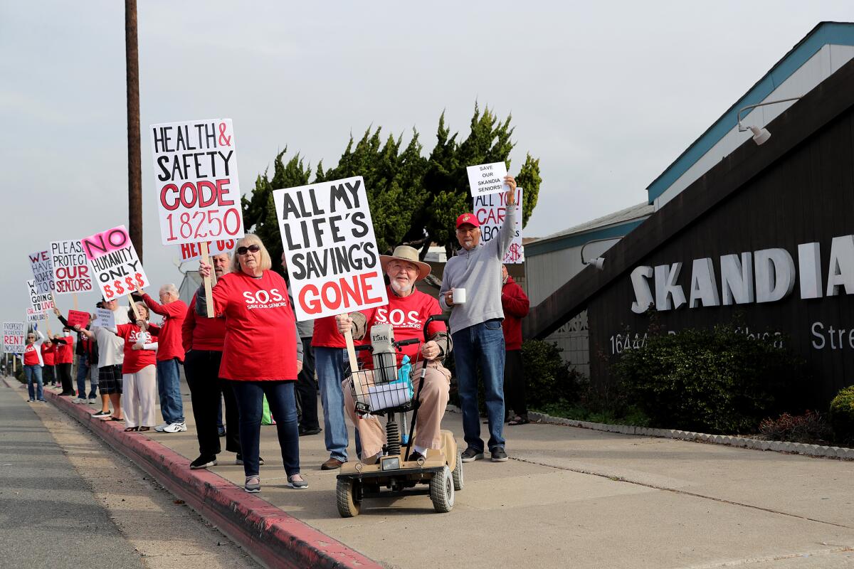 Bob Herold, 89, seated in his wheelchair, demonstrates against a rent increase.