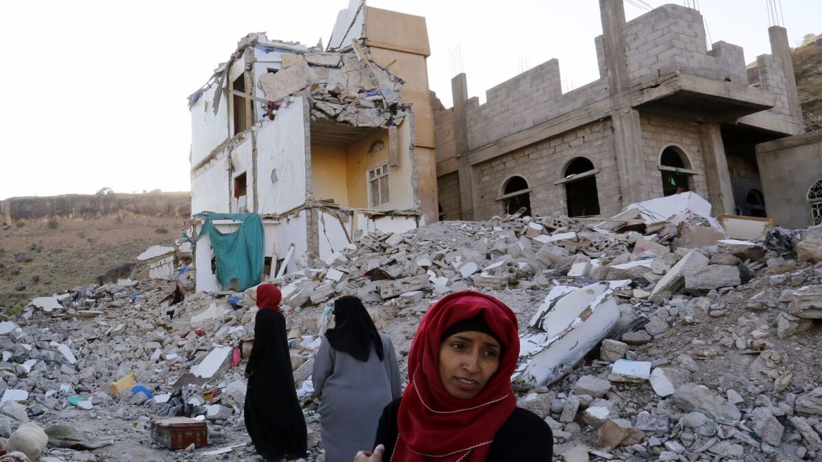 Yemeni women walk through the debris of a housing block allegedly destroyed by previous Saudi-led airstrikes in Sana'a, Yemen on Sept. 29.