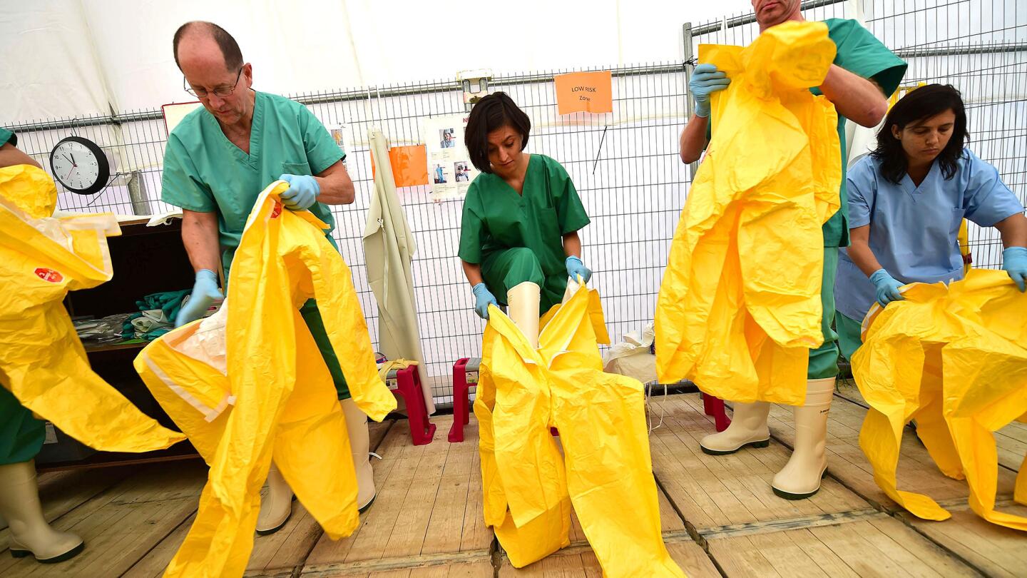 Volunteers train with Doctors Without Borders at a simulated Ebola treatment center in Brussels before going to help fight the spread of the virus in West Africa.