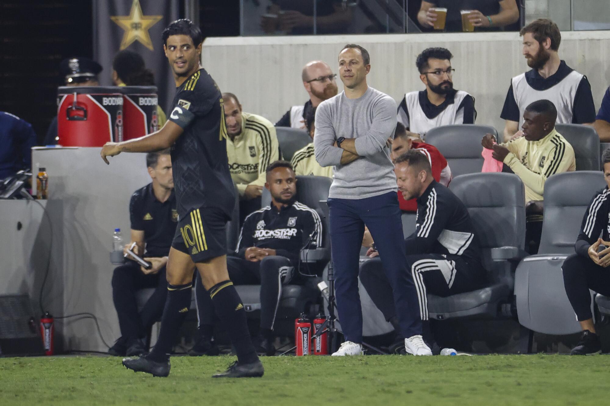LAFC coach Steve Cherundolo watches as forward Carlos Vela walks on the pitch during a 2022 match against the Galaxy.