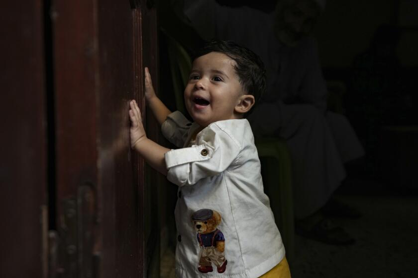 Palestinian child Ali Al-Taweel, who was born on October 7, poses for a picture at his family home in Nuseirat, as the Israeli-Hamas war marks its one year anniversary, Gaza Strip, Saturday, Oct. 5, 2024. (AP Photo/Abdel Kareem Hana)