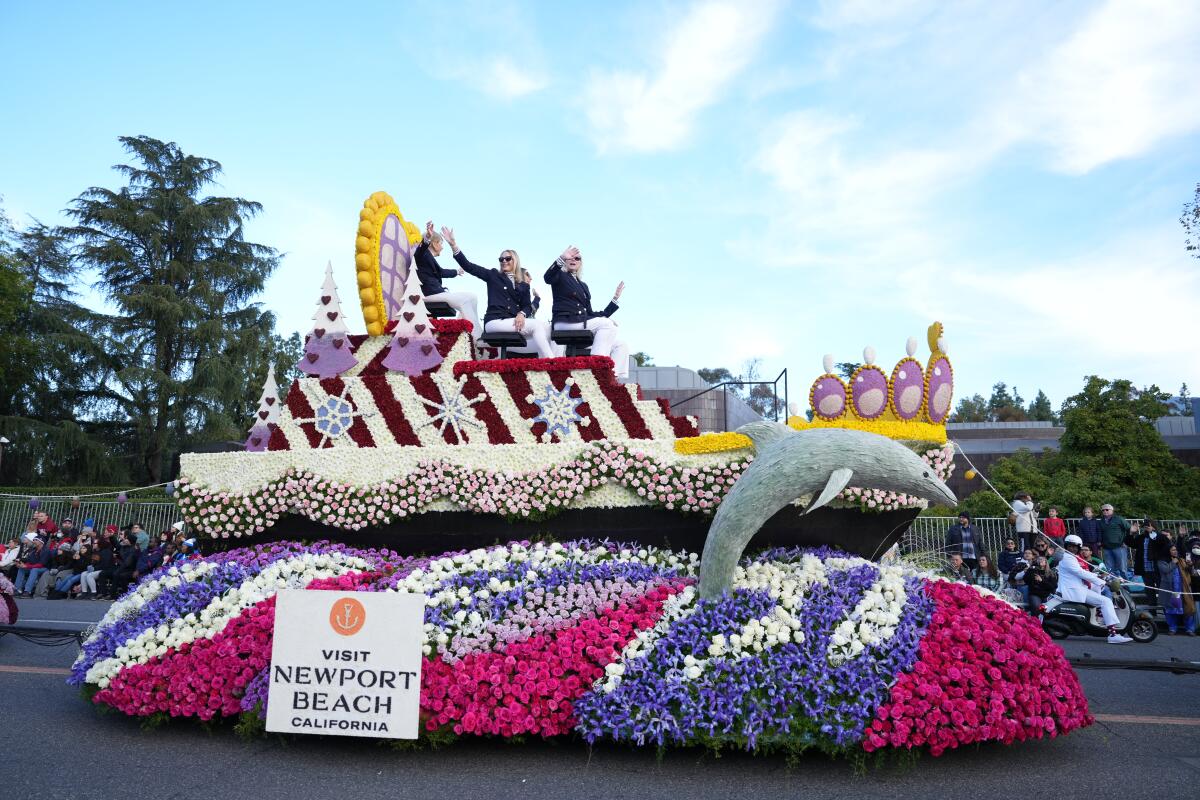 Four former Rose Queens wave from one of the Visit Newport Beach float.