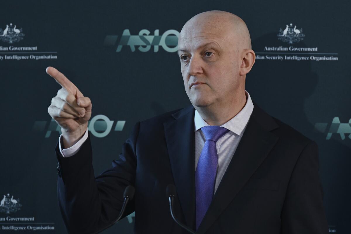 Australian intelligence official Mike Burgess pointing