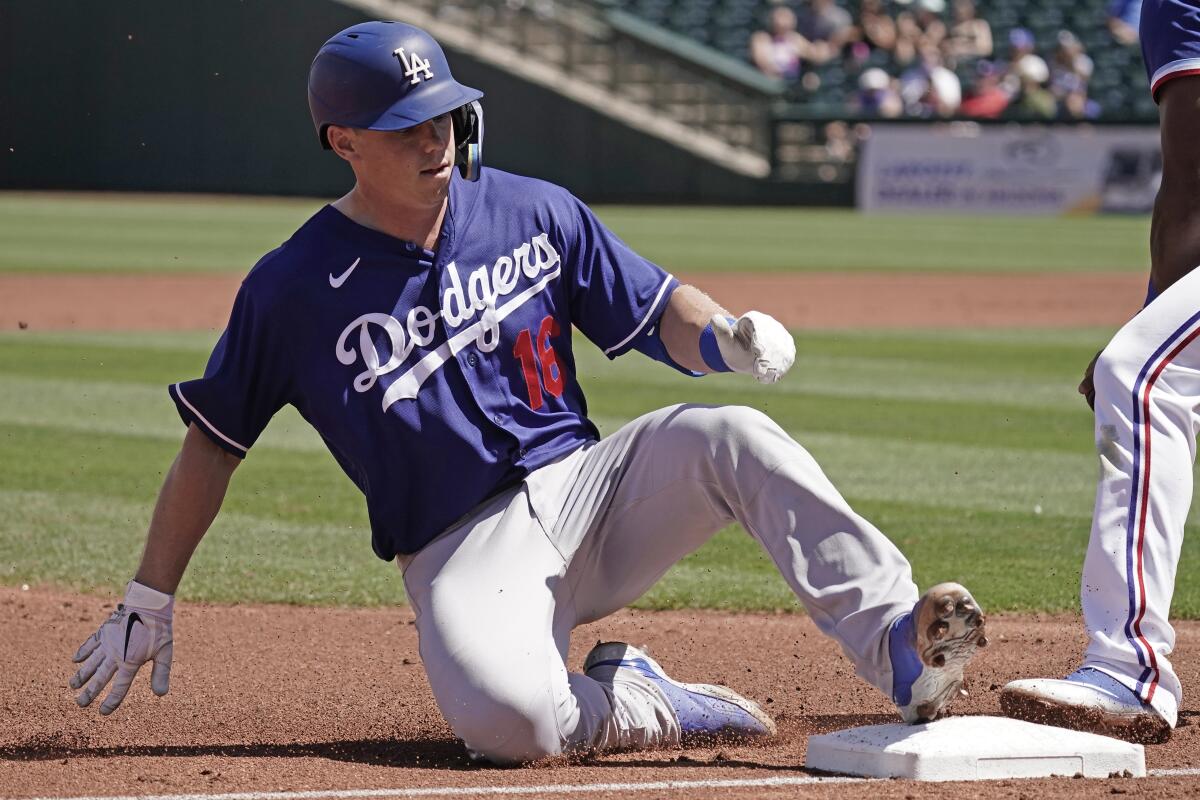 Los Angeles Dodgers' Will Smith slides to third after hitting a triple during a spring training baseball game 