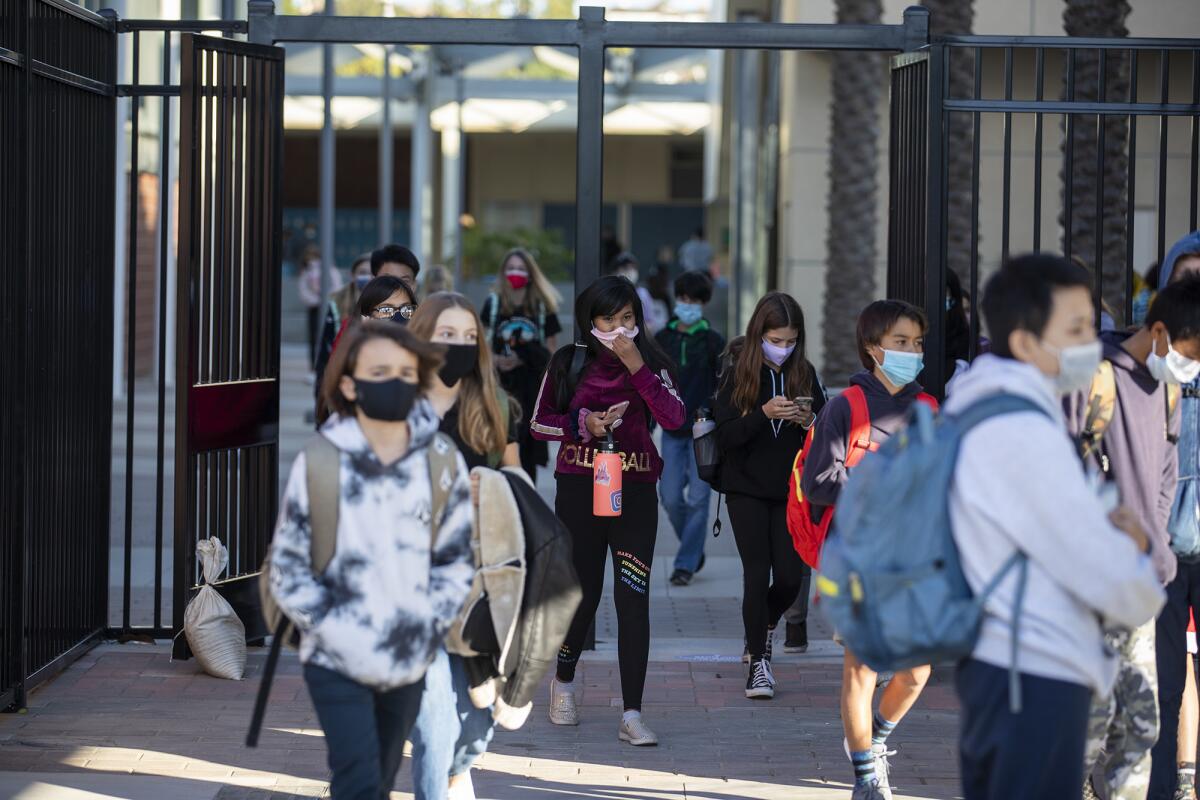 Students leave Corona del Mar High School and middle school following the first day back of in-person learning on Nov. 9.