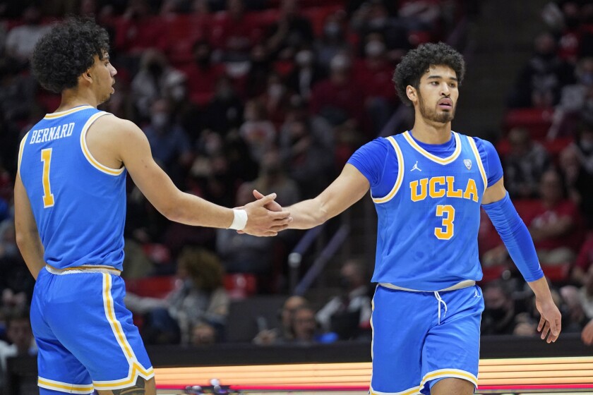 UCLA's Jules Bernard (1) congratulates Johnny Juzang (3), who scored against Utah during the first half of an NCAA college basketball game Thursday, Jan. 20, 2022, in Salt Lake City. (AP Photo/Rick Bowmer)