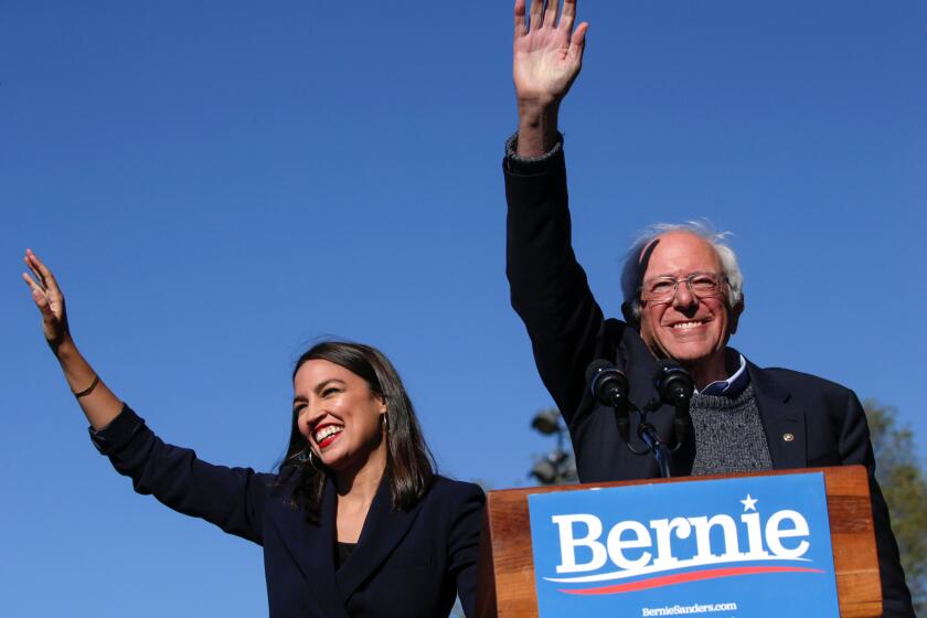 NEW YORK, NY - OCTOBER 19: Democratic presidential candidate, Sen. Bernie Sanders (D-VT) waves with Rep. Alexandria Ocasio-Cortez (D-NY) as she endorses him during his speech at a campaign rally in Queensbridge Park on October 19, 2019 in the Queens borough of New York City. This is Sanders' first rally since he paused his campaign for the nomination due to health problems. (Photo by Kena Betancur/Getty Images) ** OUTS - ELSENT, FPG, CM - OUTS * NM, PH, VA if sourced by CT, LA or MoD **
