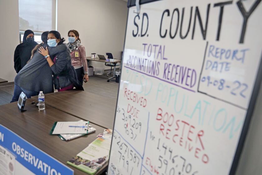 OCEANSIDE, CA-FEB.24: Medical technicians, including Sabina Kommu, fhug each other as they were closing down the COVID vaccination clinic on Friday, February 24, 2023 at The Oceanside Living Well Clinic in Oceanside. (Photo by Sandy Huffaker for The San Diego Union Tribune)