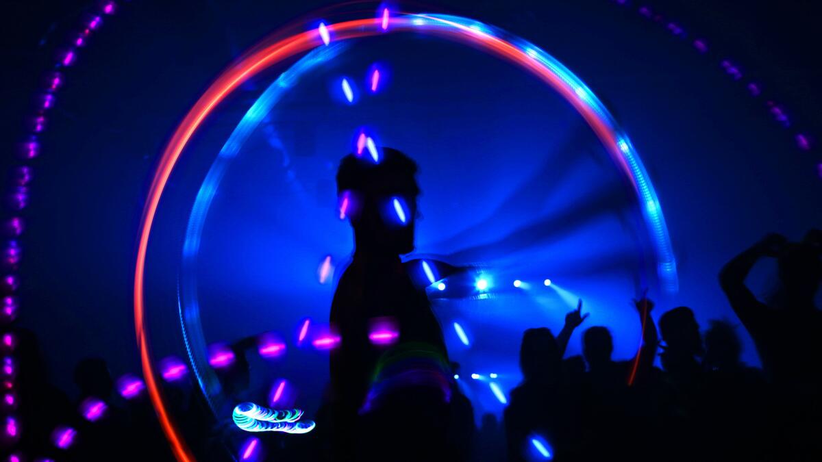 A dancer uses a lighted poi to add color to the Hard Day of the Dead rave held at the Fairplex in Pomona in November 2015.