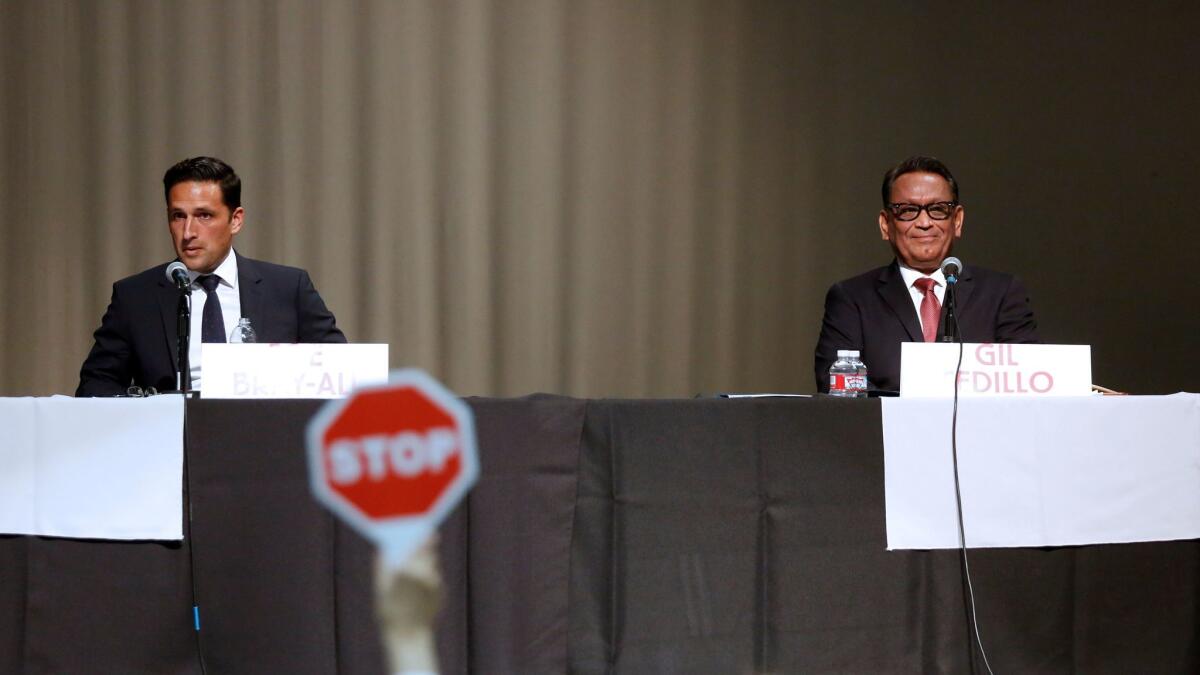 Bicycle activist Joe Bray-Ali, left, and Los Angeles City Councilman Gil Cedillo at a candidate forum in February.