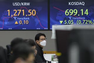 A currency trader watches computer monitors near the screens showing the foreign exchange rate between U.S. dollar and South Korean won at a foreign exchange dealing room in Seoul, South Korea, Wednesday, Dec. 28, 2022. Shares were mixed in Asia on Wednesday after a post-holiday retreat on Wall Street, as markets count down to the end of a painful year for investors.(AP Photo/Lee Jin-man)
