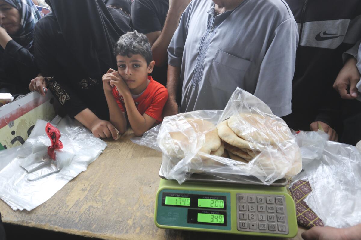 Palestinians wait to buy bread during the bombardment of the Gaza Strip.