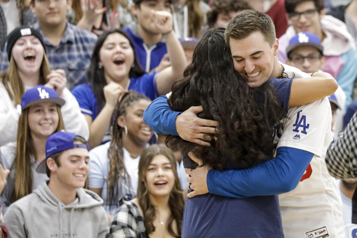 Dodgers pitcher Ross Stripling hugs student during a pep rally at Saugus High School in Santa Clarita on Friday.