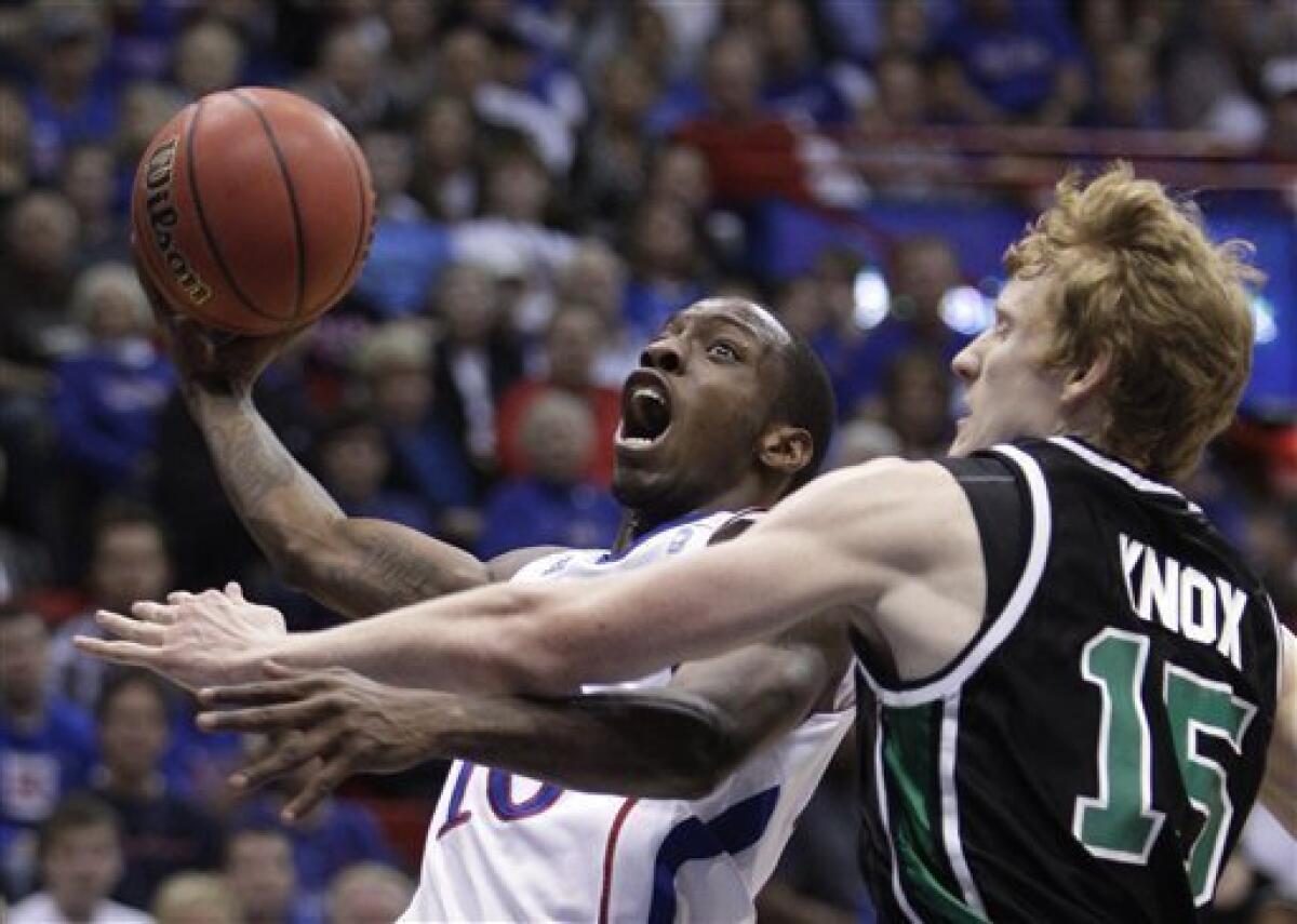 Kansas' Markieff Morris (21) with his twin brother Marcus Morris, left,  during the second half of an NCAA college basketball game against La Salle  Saturday, Dec. 12, 2009 in Kansas City, Mo. (