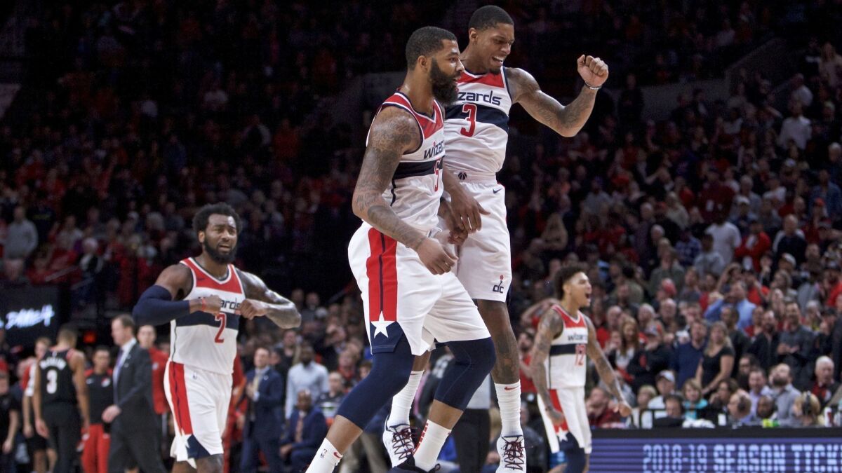 Washington Wizards forward Markieff Morris, left, and guard Bradley Beal celebrate during overtime against the Portland Trail Blazers.