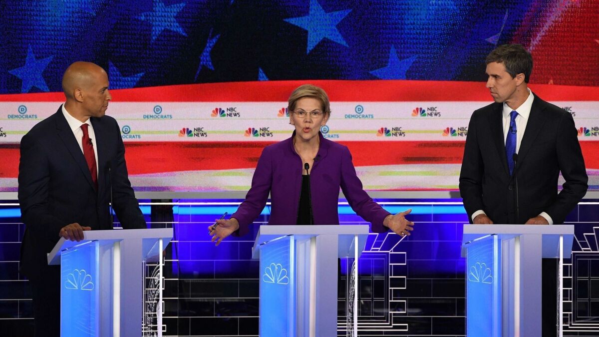 Democratic presidential hopefuls Sen. Cory Booker of New Jersey, left, Sen. Elizabeth Warren of Massachusetts and former U.S Rep. Beto O'Rourke of Texas participate in the first Democratic primary debate of the 2020 presidential campaign season.